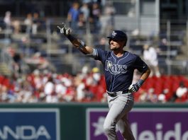 Tampa Bay Rays' Josh Lowe gestures as he runs the bases after hitting a three-run home run against Washington Nationals pitcher Jake Irvin, which scored Brandon Lowe and Junior Caminero, during the first inning of a baseball game, Saturday, Aug. 30, 2025, in Washington. (AP Photo/Terrance Williams)