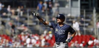 Tampa Bay Rays' Josh Lowe gestures as he runs the bases after hitting a three-run home run against Washington Nationals pitcher Jake Irvin, which scored Brandon Lowe and Junior Caminero, during the first inning of a baseball game, Saturday, Aug. 30, 2025, in Washington. (AP Photo/Terrance Williams)