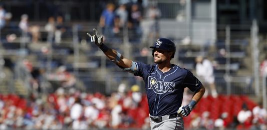 Tampa Bay Rays' Josh Lowe gestures as he runs the bases after hitting a three-run home run against Washington Nationals pitcher Jake Irvin, which scored Brandon Lowe and Junior Caminero, during the first inning of a baseball game, Saturday, Aug. 30, 2025, in Washington. (AP Photo/Terrance Williams)
