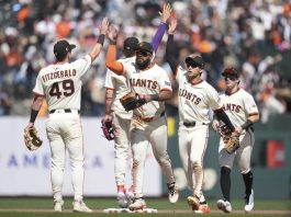 San Francisco Giants ' Tyler Fitzgerald, left, celebrates with Willy Adames, middle rear, Heliot Ramos, middle, Jung Hoo Lee, second from right, and Drew Gilbert after a baseball game against the Tampa Bay Rays in San Francisco, Sunday, Aug. 17, 2025. (AP Photo/Jeff Chiu)