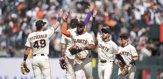 San Francisco Giants ' Tyler Fitzgerald, left, celebrates with Willy Adames, middle rear, Heliot Ramos, middle, Jung Hoo Lee, second from right, and Drew Gilbert after a baseball game against the Tampa Bay Rays in San Francisco, Sunday, Aug. 17, 2025. (AP Photo/Jeff Chiu)