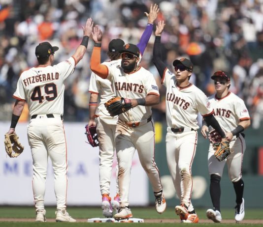 San Francisco Giants ' Tyler Fitzgerald, left, celebrates with Willy Adames, middle rear, Heliot Ramos, middle, Jung Hoo Lee, second from right, and Drew Gilbert after a baseball game against the Tampa Bay Rays in San Francisco, Sunday, Aug. 17, 2025. (AP Photo/Jeff Chiu)