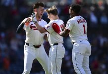 Cleveland Guardians' Kyle Manzardo, center, is congratulated by Angel Martinez, right, and Nolan Jones, left, after driving in the game winning run in the 10th inning of a baseball game against the Tampa Bay Rays, Wednesday, Aug. 27, 2025, in Cleveland. (AP Photo/David Dermer)
