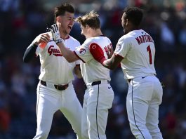 Cleveland Guardians' Kyle Manzardo, center, is congratulated by Angel Martinez, right, and Nolan Jones, left, after driving in the game winning run in the 10th inning of a baseball game against the Tampa Bay Rays, Wednesday, Aug. 27, 2025, in Cleveland. (AP Photo/David Dermer)