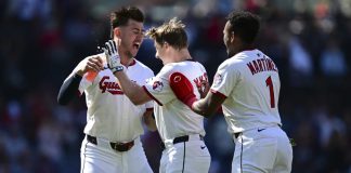 Cleveland Guardians' Kyle Manzardo, center, is congratulated by Angel Martinez, right, and Nolan Jones, left, after driving in the game winning run in the 10th inning of a baseball game against the Tampa Bay Rays, Wednesday, Aug. 27, 2025, in Cleveland. (AP Photo/David Dermer)