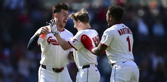 Cleveland Guardians' Kyle Manzardo, center, is congratulated by Angel Martinez, right, and Nolan Jones, left, after driving in the game winning run in the 10th inning of a baseball game against the Tampa Bay Rays, Wednesday, Aug. 27, 2025, in Cleveland. (AP Photo/David Dermer)