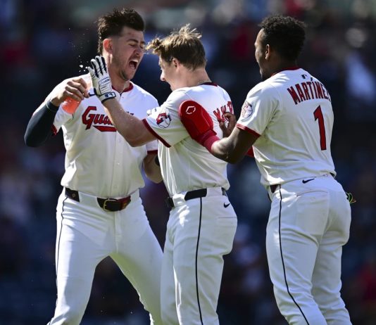 Cleveland Guardians' Kyle Manzardo, center, is congratulated by Angel Martinez, right, and Nolan Jones, left, after driving in the game winning run in the 10th inning of a baseball game against the Tampa Bay Rays, Wednesday, Aug. 27, 2025, in Cleveland. (AP Photo/David Dermer)