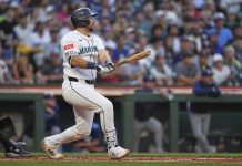 Seattle Mariners' Cal Raleigh follows through on a three-run home run against the Tampa Bay Rays during the third inning of a baseball game Saturday, Aug. 9, 2025, in Seattle. (AP Photo/Lindsey Wasson)