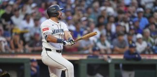 Seattle Mariners' Cal Raleigh follows through on a three-run home run against the Tampa Bay Rays during the third inning of a baseball game Saturday, Aug. 9, 2025, in Seattle. (AP Photo/Lindsey Wasson)