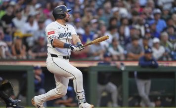 Seattle Mariners' Cal Raleigh follows through on a three-run home run against the Tampa Bay Rays during the third inning of a baseball game Saturday, Aug. 9, 2025, in Seattle. (AP Photo/Lindsey Wasson)
