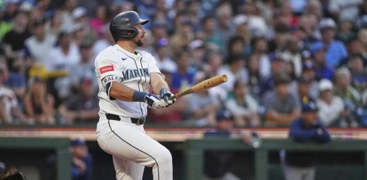 Seattle Mariners' Cal Raleigh follows through on a three-run home run against the Tampa Bay Rays during the third inning of a baseball game Saturday, Aug. 9, 2025, in Seattle. (AP Photo/Lindsey Wasson)