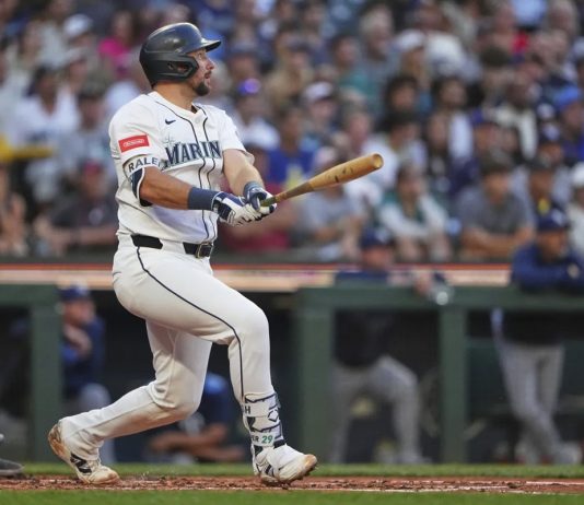 Seattle Mariners' Cal Raleigh follows through on a three-run home run against the Tampa Bay Rays during the third inning of a baseball game Saturday, Aug. 9, 2025, in Seattle. (AP Photo/Lindsey Wasson)