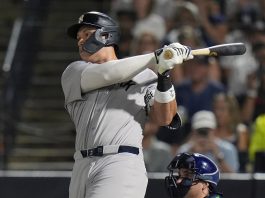 New York Yankees' Aaron Judge watches his solo home run off Tampa Bay Rays pitcher Shane Baz during the first inning of a baseball game Tuesday, Aug. 19, 2025, in Tampa, Fla. (AP Photo/Chris O'Meara)