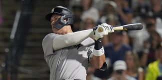 New York Yankees' Aaron Judge watches his solo home run off Tampa Bay Rays pitcher Shane Baz during the first inning of a baseball game Tuesday, Aug. 19, 2025, in Tampa, Fla. (AP Photo/Chris O'Meara)