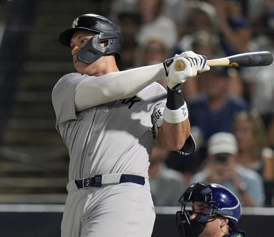 New York Yankees' Aaron Judge watches his solo home run off Tampa Bay Rays pitcher Shane Baz during the first inning of a baseball game Tuesday, Aug. 19, 2025, in Tampa, Fla. (AP Photo/Chris O'Meara)