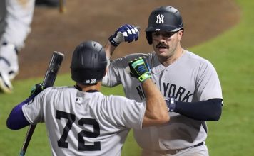 Dodgers -New York Yankees' Austin Wells (28) celebrates with José Caballero (72) after Wells hit a home run off Tampa Bay Rays pitcher Pete Fairbanks during the 10th inning of a baseball game Wednesday, Aug. 20, 2025, in Tampa, Fla. (AP Photo/Chris O'Meara)