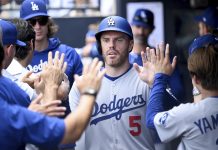 Los Angeles Dodgers' Freddie Freeman (5) celebrates after scoring on a single by Andy Pages during the sixth inning of a baseball game against the Tampa Bay Rays, Sunday, Aug. 3, 2025, in Tampa, Fla. (AP Photo/Jason Behnken)