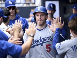 Los Angeles Dodgers' Freddie Freeman (5) celebrates after scoring on a single by Andy Pages during the sixth inning of a baseball game against the Tampa Bay Rays, Sunday, Aug. 3, 2025, in Tampa, Fla. (AP Photo/Jason Behnken)