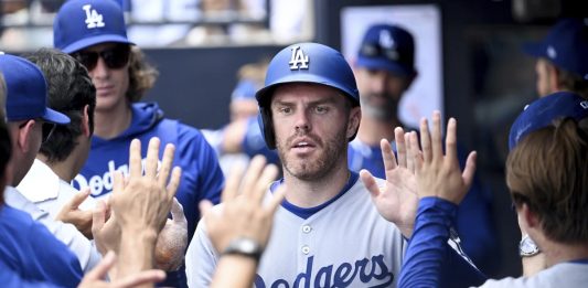 Los Angeles Dodgers' Freddie Freeman (5) celebrates after scoring on a single by Andy Pages during the sixth inning of a baseball game against the Tampa Bay Rays, Sunday, Aug. 3, 2025, in Tampa, Fla. (AP Photo/Jason Behnken)