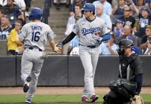 Los Angeles Dodgers' Will Smith (16) and Shohei Ohtani (17) score on a double by Freddie Freeman (not pictured) during the first inning of a baseball game against the Tampa Bay Rays Friday, Aug. 1, 2025, in Tampa, Fla. (AP Photo/Jason Behnken)