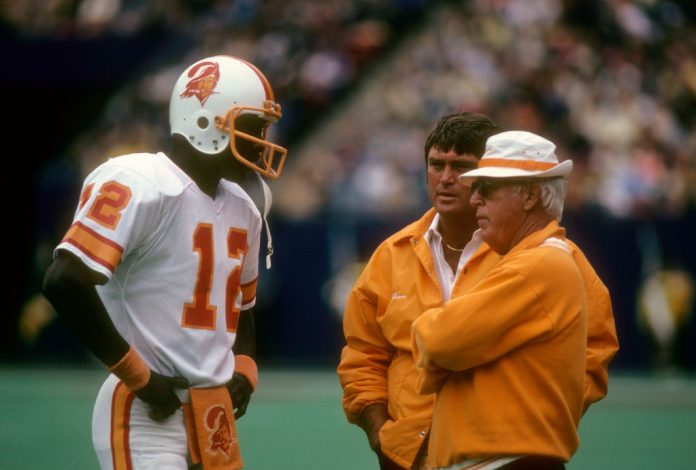 Tampa Bay Buccaneers Quarterback Doug Williams #12 of the Tampa Bay Buccaneers talking with Head Coach John McKay (R) circa 1978 during an NFL football game. Williams played for the Buccaneers from 1978-82.AP PHOTOS