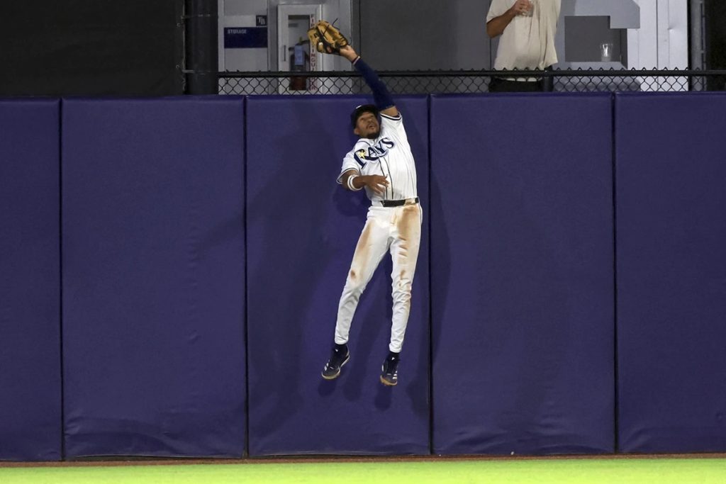 Tampa Bay Rays outfielder Chandler Simpson makes a leaping catch on a fly ball from Toronto Blue Jays' Alejandro Kirk during the fourth inning of a baseball game Wednesday, Sept. 17, 2025, in Tampa, Fla. (AP Photo/Mike Carlson)