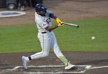 Tampa Bay Rays' Junior Caminero lines an RBI single off Seattle Mariners pitcher Bryan Woo during the first inning of a baseball game Tuesday, Sept. 2, 2025, in Tampa, Fla. (AP Photo/Chris O'Meara)