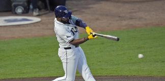 Tampa Bay Rays' Junior Caminero lines an RBI single off Seattle Mariners pitcher Bryan Woo during the first inning of a baseball game Tuesday, Sept. 2, 2025, in Tampa, Fla. (AP Photo/Chris O'Meara)
