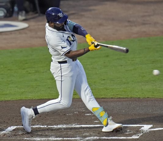 Tampa Bay Rays' Junior Caminero lines an RBI single off Seattle Mariners pitcher Bryan Woo during the first inning of a baseball game Tuesday, Sept. 2, 2025, in Tampa, Fla. (AP Photo/Chris O'Meara)
