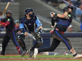 Toronto Blue Jays' Nathan Lukes (38) hits a two-run home run off Tampa Bay Rays pitcher Adrian Houser as Rays catcher Hunter Feduccia (30) looks on during fifth inning MLB baseball action in Toronto on Friday, Sept. 26, 2025. (Chris Young/The Canadian Press via AP)
