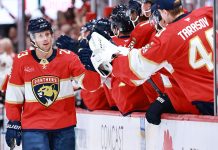 Carter Verhaeghe #23 of the Florida Panthers high fives teammates after scoring against the Chicago Blackhawks during the first period at Amerant Bank Arena on October 07, 2025 in Sunrise, Florida.