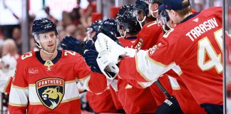 Carter Verhaeghe #23 of the Florida Panthers high fives teammates after scoring against the Chicago Blackhawks during the first period at Amerant Bank Arena on October 07, 2025 in Sunrise, Florida.