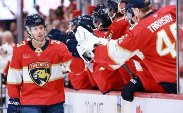 Carter Verhaeghe #23 of the Florida Panthers high fives teammates after scoring against the Chicago Blackhawks during the first period at Amerant Bank Arena on October 07, 2025 in Sunrise, Florida.